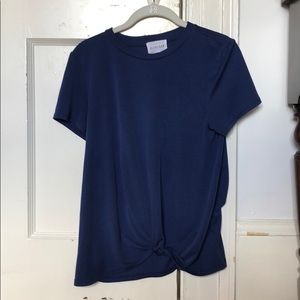 Royal blue shirt with knot at the bottom.